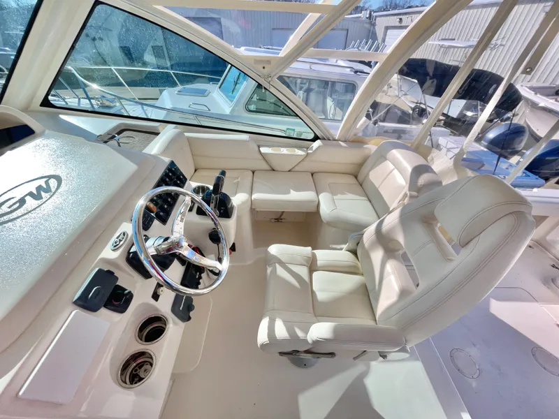 Slide: The Image of 2015 Grady-White Express 330 boat interior with white seating and steering wheel. - 25