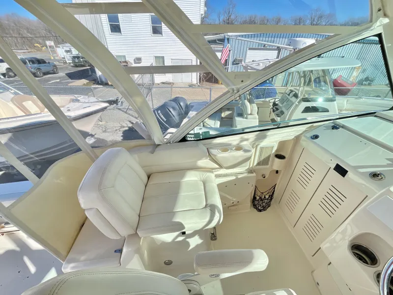 Slide: The Image of 2015 Grady-White Express 330 boat interior with white seating and control panel. - 27