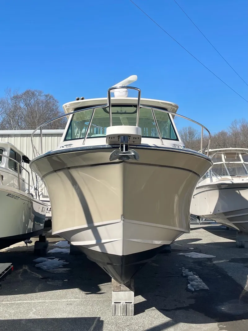 Slide: The Image of 2015 Grady-White Express 330 boat on display, front view, clear blue sky. - 3