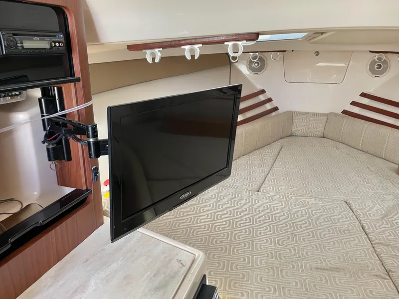 Slide: The Image of 2015 Grady-White Express 330 cabin interior with TV and seating area. - 35