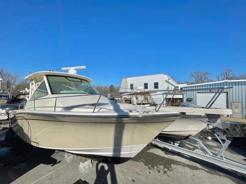 Slide: The Image of 2015 Grady-White Express 330 boat on trailer under clear blue sky. - 4