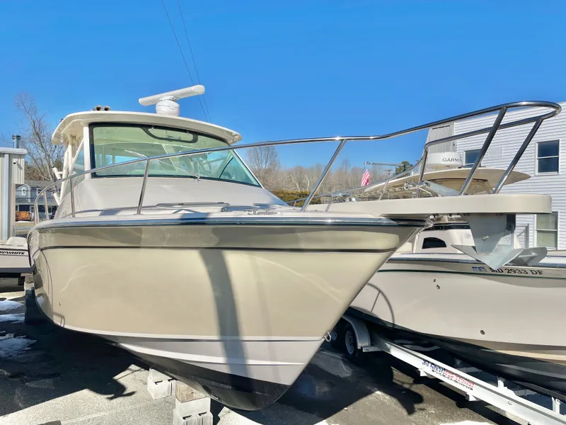 Slide: The Image of 2015 Grady-White Express 330 boat on trailer, parked outdoors under clear blue sky. - 5