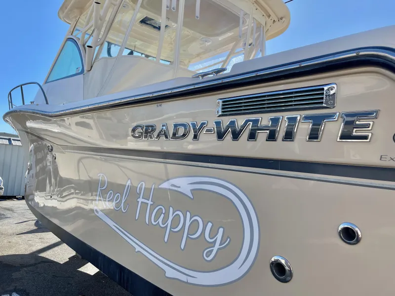 Slide: The Image of 2015 Grady-White Express 330 boat with "Reel Happy" decal on the side. - 6