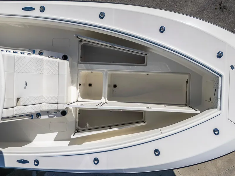 Slide: The Image of 2019 SeaVee 322z boat interior with open storage compartments and seating. - 18