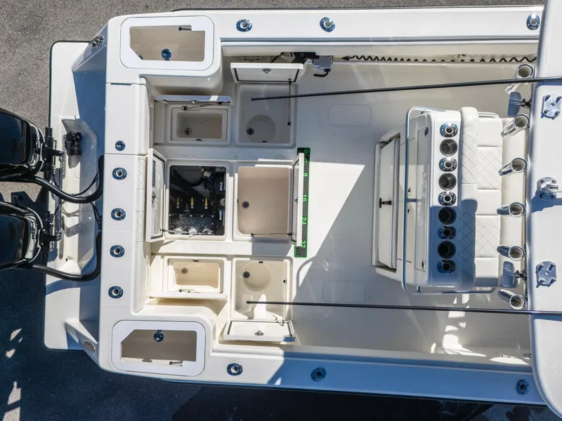 Slide: The Image of 2019 SeaVee 322z boat interior with storage compartments and dual engines. - 24