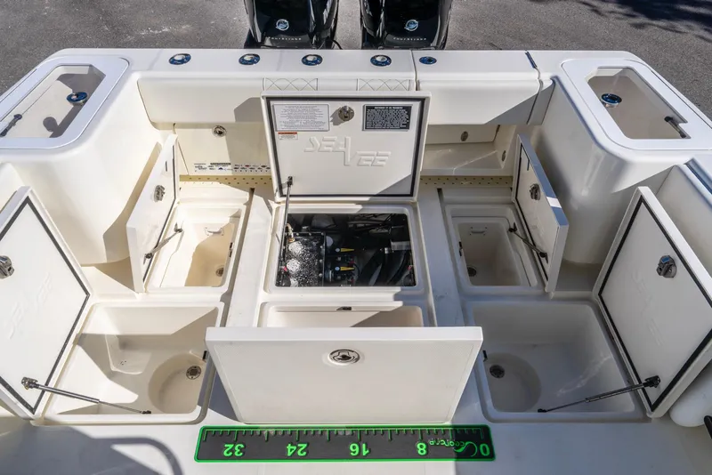 Slide: The Image of 2019 SeaVee 322z boat storage compartments and engine access, open for viewing. - 25