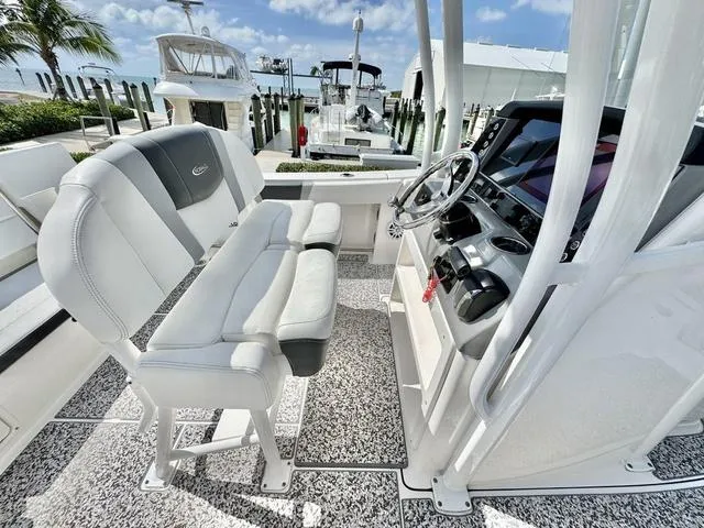 Slide: The Image of 2023 Robalo R230 boat interior with helm, seating, and modern dashboard. - 10