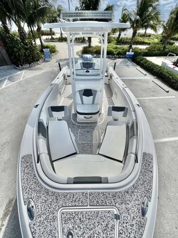 Slide: The Image of 2023 Robalo R230 boat with sleek design, parked near palm trees. - 13