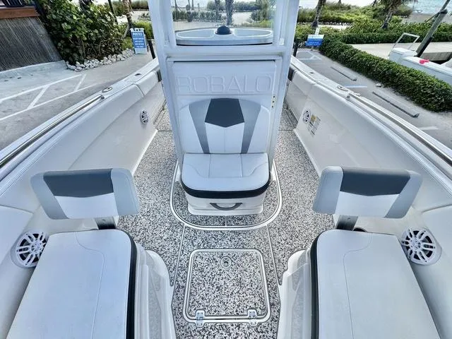 Slide: The Image of 2023 Robalo R230 boat interior with white seating and modern design. - 14