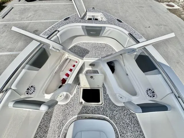 Slide: The Image of 2023 Robalo R230 boat interior with open storage compartments and seating. - 17