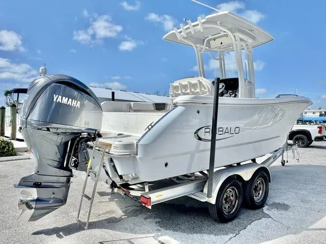 Slide: The Image of 2023 Robalo R230 boat on trailer with Yamaha engine, parked outdoors. - 18