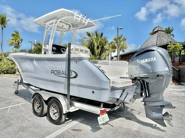 Slide: The Image of 2023 Robalo R230 boat with Yamaha engine on trailer, parked outdoors. - 3