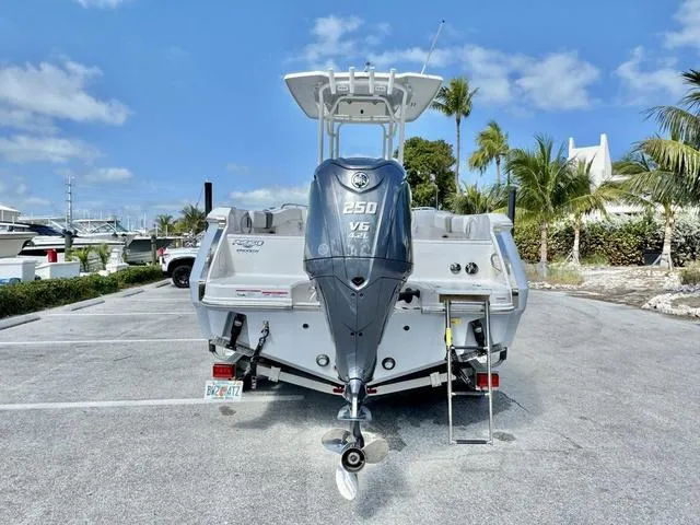 Slide: The Image of 2023 Robalo R230 boat with 250 V6 engine, parked in a sunny marina. - 4