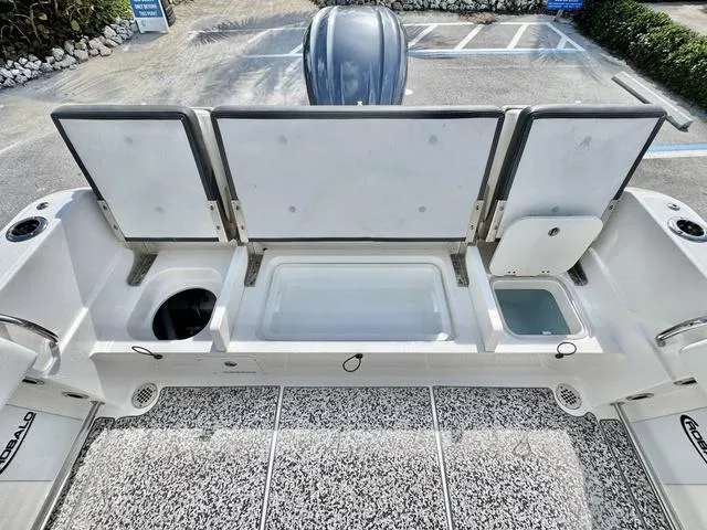 Slide: The Image of 2023 Robalo R230 boat storage compartments and seating area, showcasing spacious design. - 7
