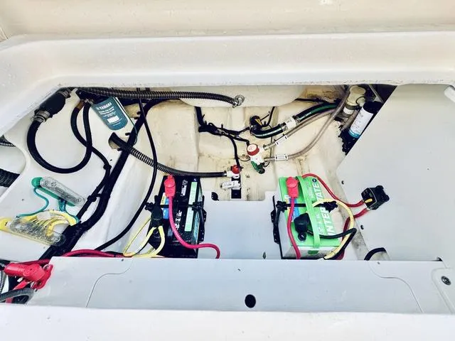 Slide: The Image of 2023 Robalo R230 boat battery compartment with wiring and components. - 8