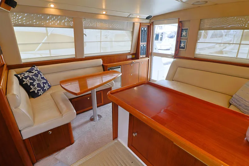 Slide: The Image of Luxurious interior of 2000 Riviera Flybridge Convertible yacht with elegant wood finishes. - 12