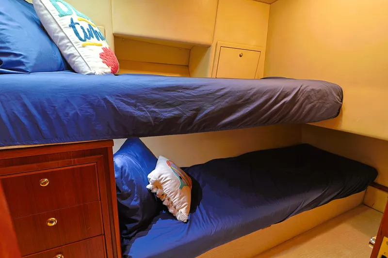 Slide: The Image of Bunk beds in 2000 Riviera Flybridge Convertible yacht cabin with blue bedding. - 19