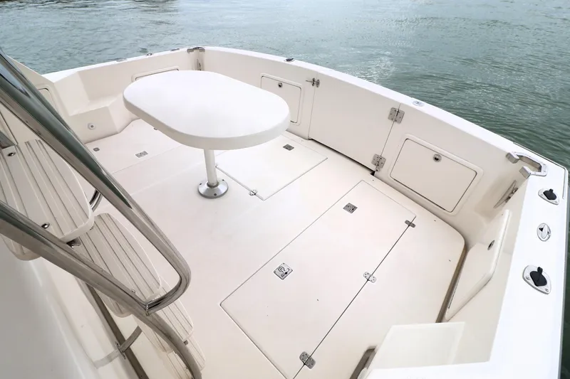 Slide: The Image of 2000 Riviera Flybridge Convertible boat deck with seating and table, overlooking water. - 23
