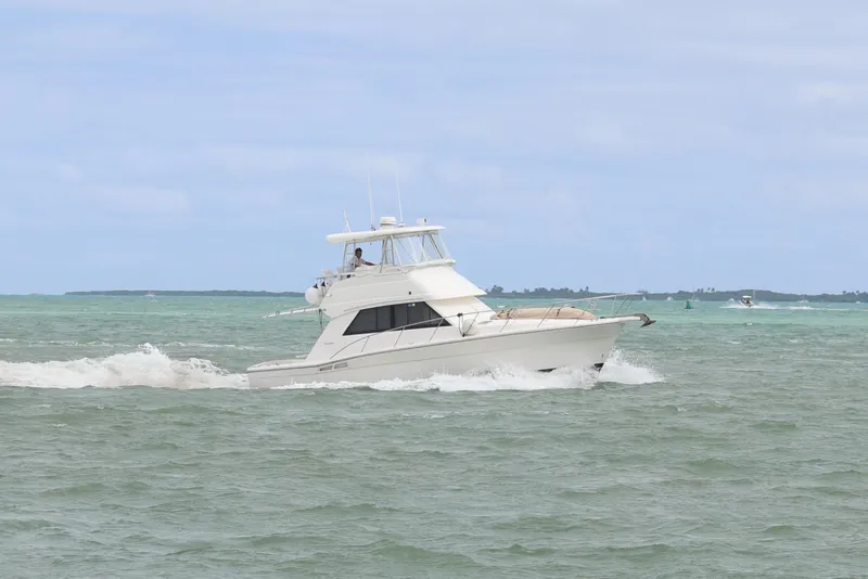 Slide: The Image of 2000 Riviera Flybridge Convertible cruising on open water. - 29