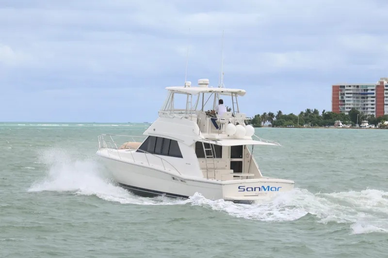 Slide: The Image of 2000 Riviera Flybridge Convertible yacht cruising on open water. - 7