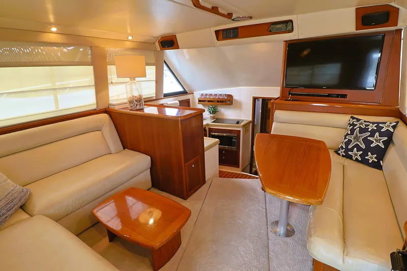 Slide: The Image of Luxurious interior of 2000 Riviera Flybridge Convertible yacht with plush seating and modern amenities. - 9