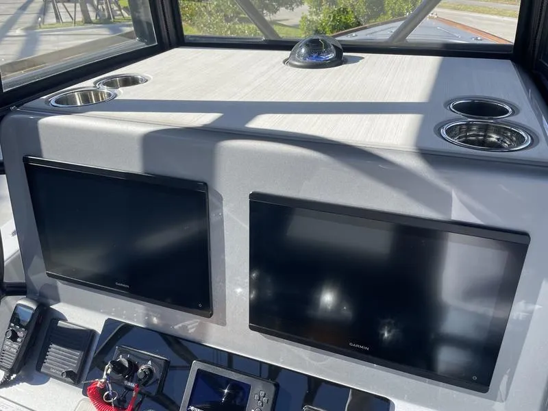 Slide: The Image of Helm of 2020 Stuart 27 CC boat with dual screens and cup holders. - 19