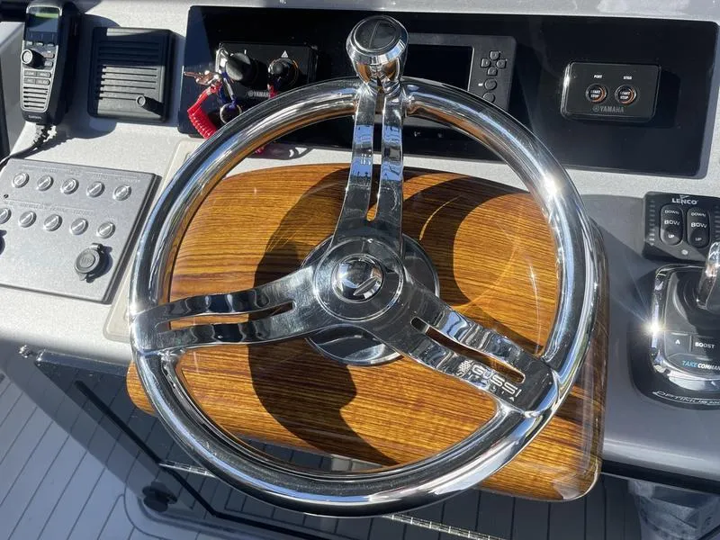 Slide: The Image of Steering wheel of 2020 Stuart 27 CC boat with wood and chrome finish. - 20