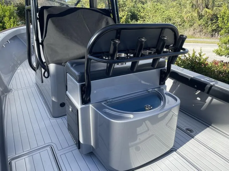 Slide: The Image of 2020 Stuart 27 CC boat interior with rod holders and seating. - 27