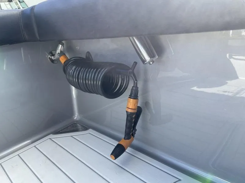 Slide: The Image of Coiled hose and nozzle on 2020 Stuart 27 CC boat deck. - 29