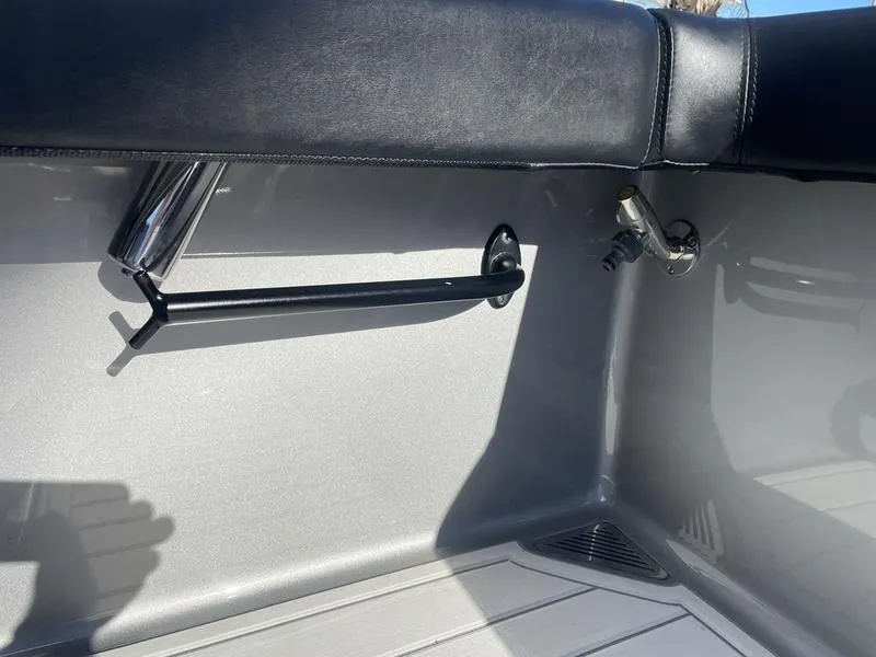Slide: The Image of Interior detail of a 2020 Stuart 27 CC boat, featuring a rod holder and sleek design. - 30