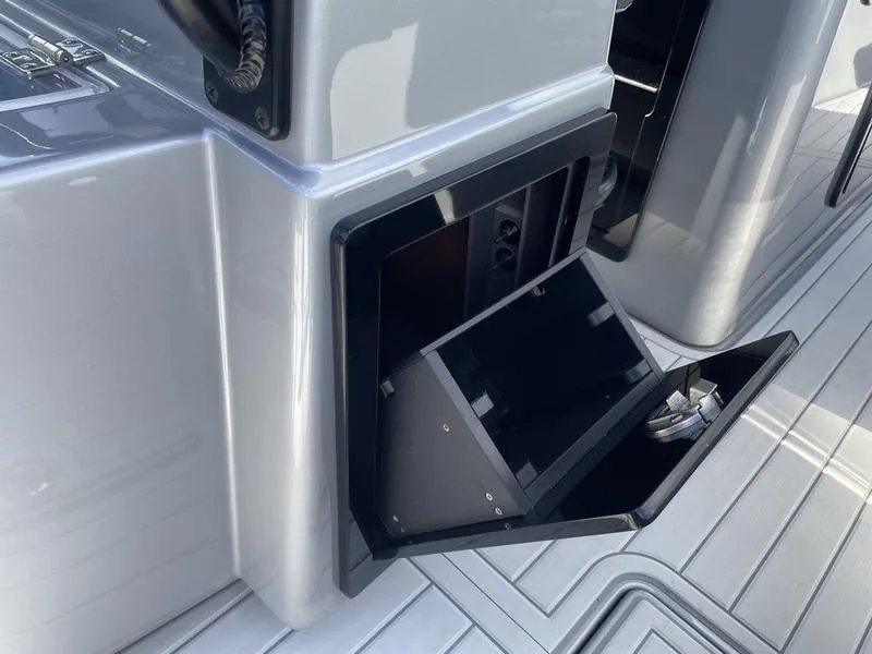 Slide: The Image of 2020 Stuart 27 CC boat storage compartment with open hatch on deck. - 33