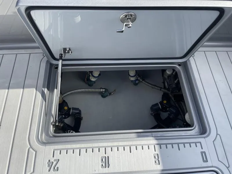 Slide: The Image of Open hatch on 2020 Stuart 27 CC boat showing internal components and ruler markings. - 34