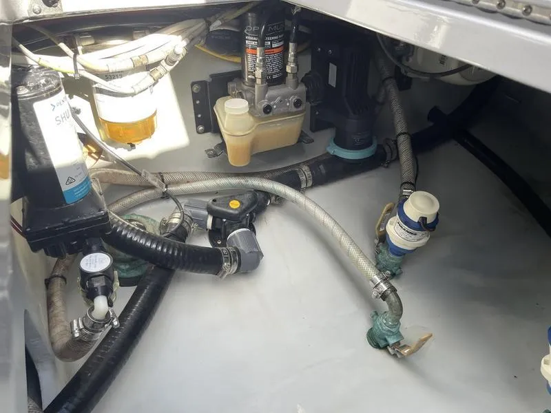 Slide: The Image of Engine compartment of a 2020 Stuart 27 CC boat, showing hoses and mechanical components. - 36