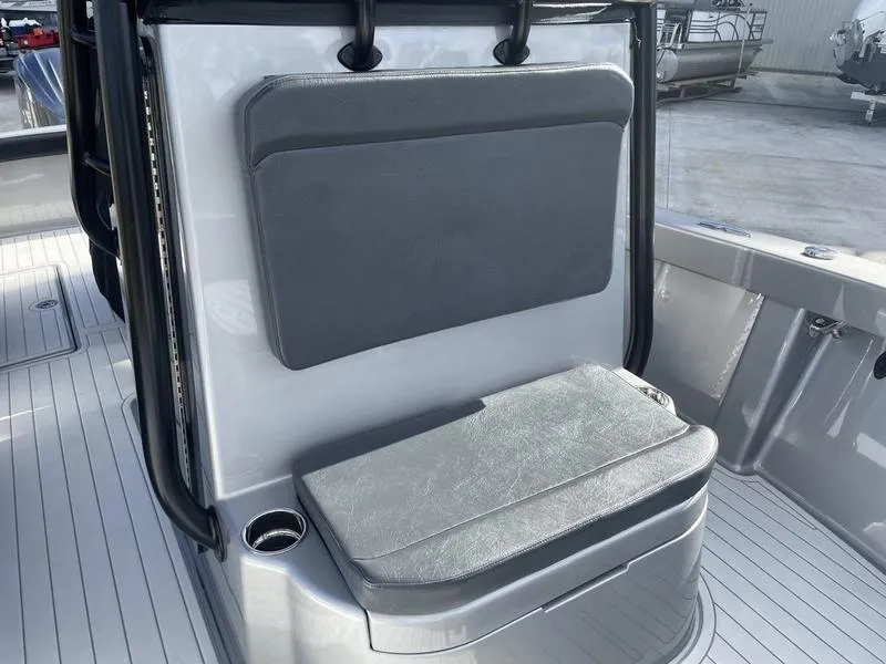 Slide: The Image of 2020 Stuart 27 CC boat interior with cushioned seating and cup holder. - 39