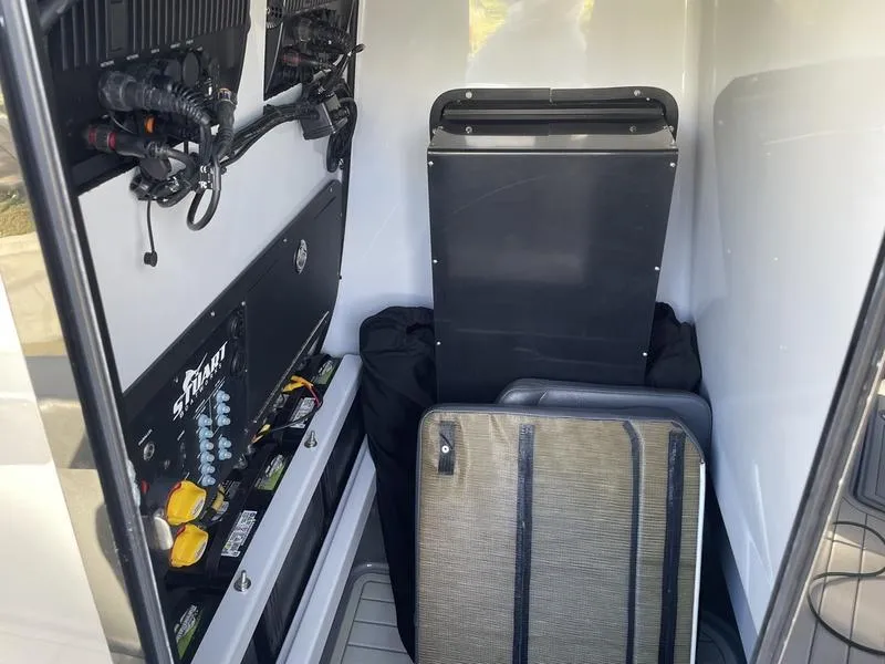 Slide: The Image of Interior of a 2020 Stuart 27 CC boat, featuring storage and electrical components. - 41