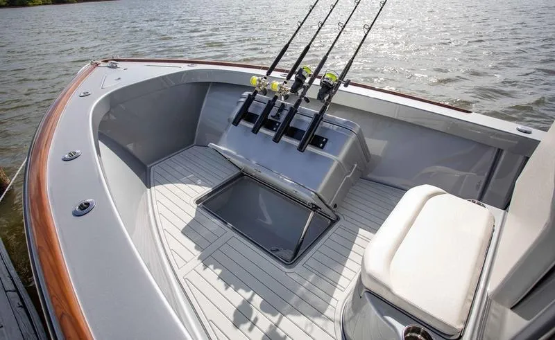 Slide: The Image of 2020 Stuart 27 CC boat with fishing rods on deck by the water. - 6