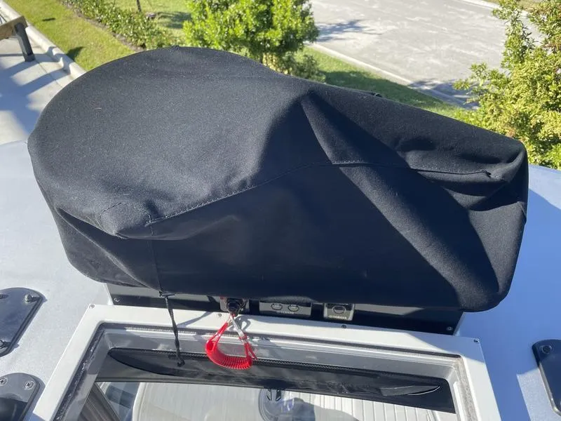 Slide: The Image of Covered equipment on 2020 Stuart 27 CC boat, outdoors with greenery in background. - 7