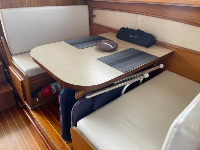 Slide: The Image of Interior of 1967 Hatteras 28 Cruiser with dining area, wooden accents, and seating. - 11