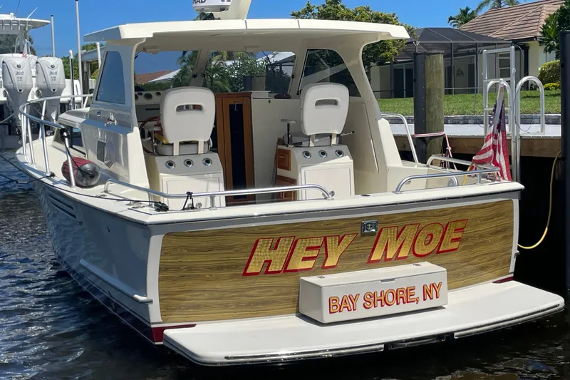 Slide: The Image of 1967 Hatteras 28 Cruiser named "Hey Moe" docked in Bay Shore, NY. - 2