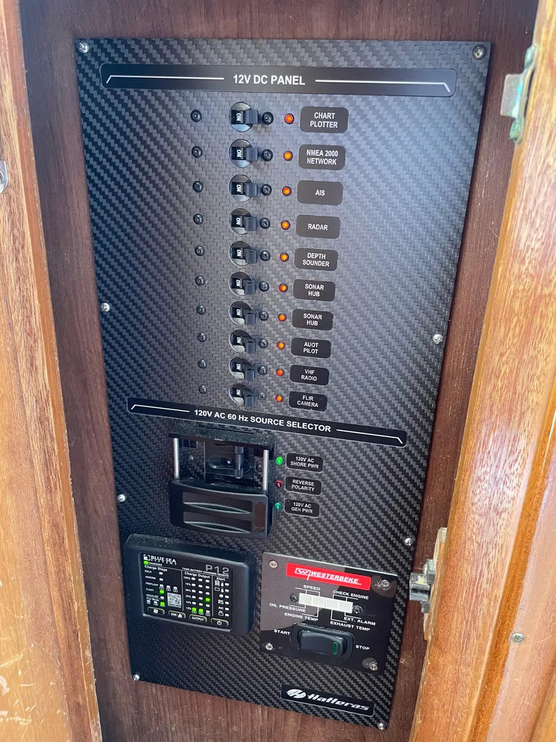 Slide: The Image of Electrical panel on a 1967 Hatteras 28 Cruiser boat, featuring 12V DC and 120V AC controls. - 20