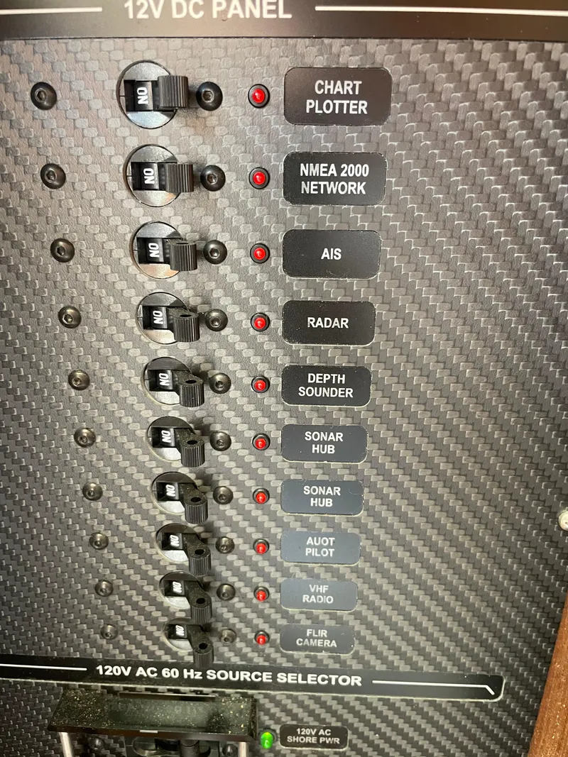 Slide: The Image of Control panel of a 1967 Hatteras 28 Cruiser with various switches and indicators. - 25