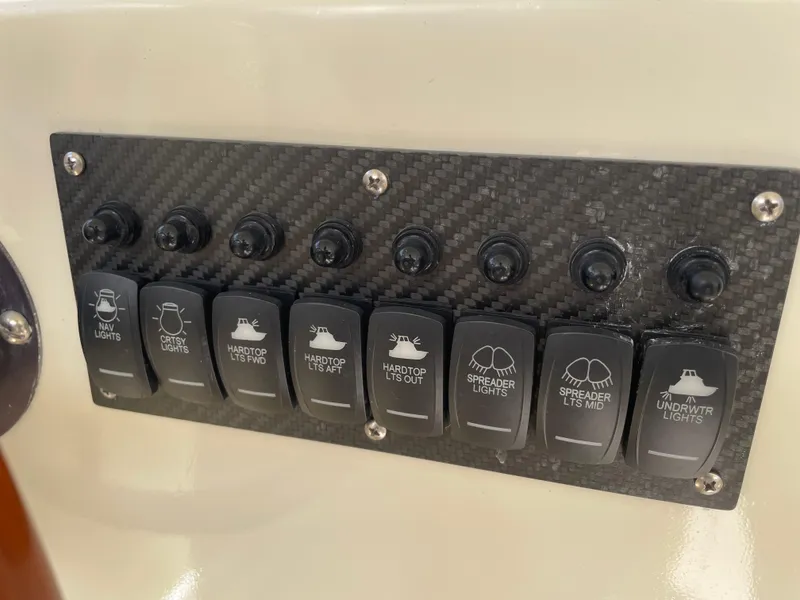 Slide: The Image of Control panel of 1967 Hatteras 28 Cruiser with labeled switches for various boat lights. - 34