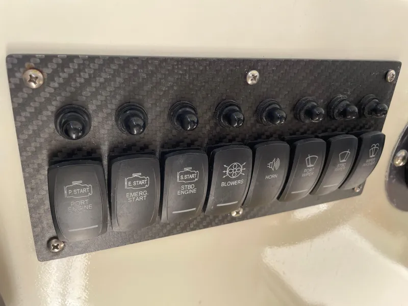 Slide: The Image of Control panel of a 1967 Hatteras 28 Cruiser boat with labeled switches. - 35