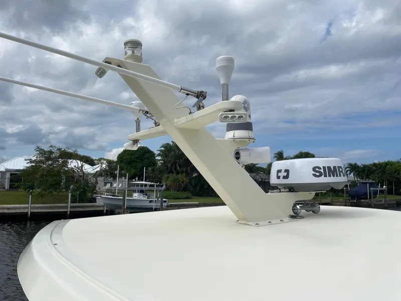 Slide: The Image of 1967 Hatteras 28 Cruiser boat with radar and antennas, docked under cloudy skies. - 42