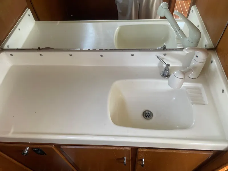 Slide: The Image of 1967 Hatteras 28 Cruiser bathroom sink with mirror and faucet. - 16