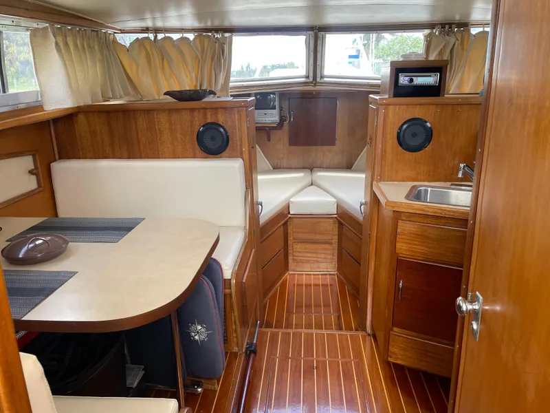Slide: The Image of Interior of a 1967 Hatteras 28 Cruiser with wood paneling and seating area. - 23