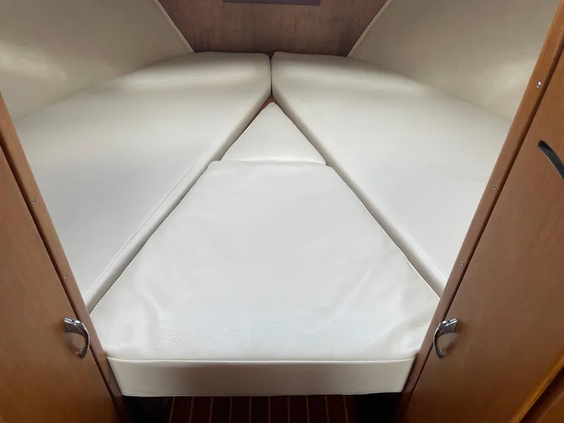 Slide: The Image of Interior cabin of 1967 Hatteras 28 Cruiser with white cushioned V-berth. - 26