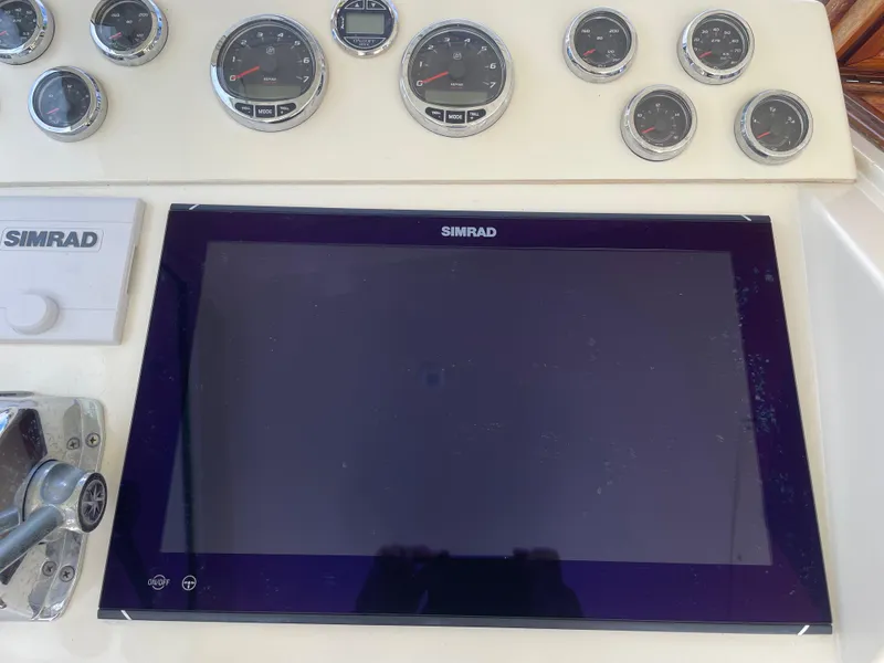 Slide: The Image of Control panel of 1967 Hatteras 28 Cruiser with Simrad display and gauges. - 30