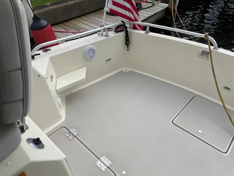 Slide: The Image of 1967 Hatteras 28 Cruiser boat deck with American flag and dock in background. - 40