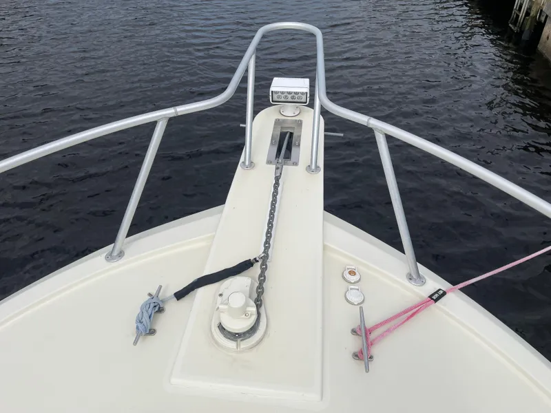 Slide: The Image of Bow of 1967 Hatteras 28 Cruiser with anchor chain and railing on calm water. - 43